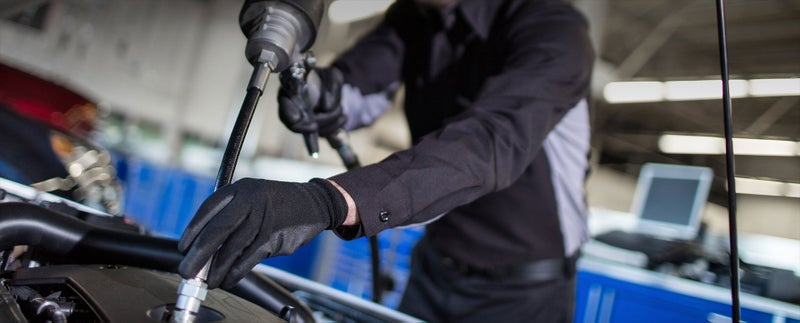 Close up image of service technician working on a car - Bergstrom Chevrolet GMC of Manitowoc in MANITOWOC WI
